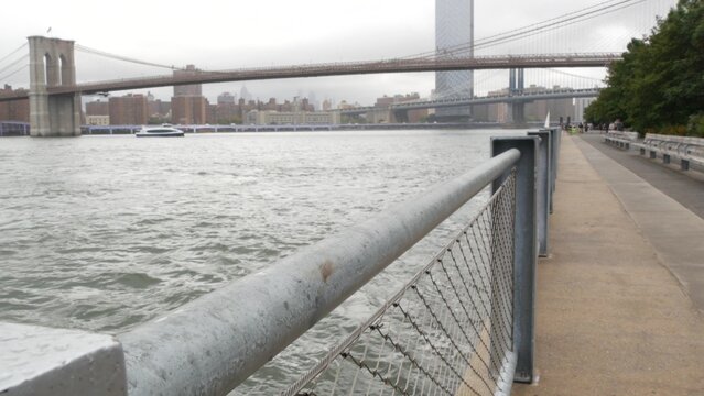 Brooklyn Bridge, Manhattan Bridge from Brooklyn Bridge park, New York City Dumbo, United States. American architecture, famous tourist landmark. Waterfront promenade, riverside esplanade perspective.