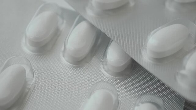 Pills in packaging on a flat surface with close up view