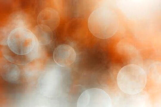 Abstract background featuring warm orange and beige bokeh circles with soft glowing effects