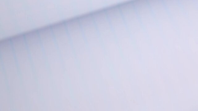 Flipping through the pages of a squared notebook, notebook paper background