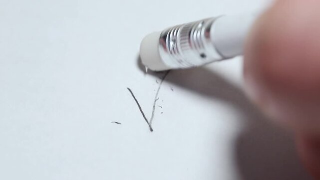 Rubbing with an eraser and pencil on a white sheet of paper