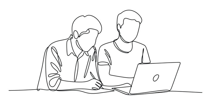 Two young men working together on a laptop computer