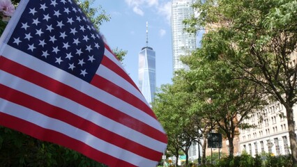 Naklejka premium Lower Manhattan Downtown Financial District, New York City, United States. World Trade Center skyscraper building, Freedom tower, Battery park. Summer trees greenery on West street. American USA flag.