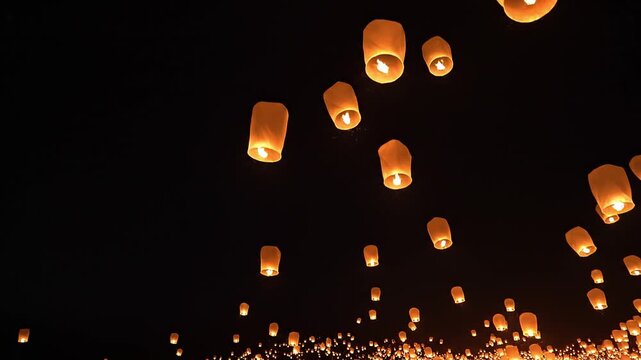 Many Glowing Paper Lanterns Floating Into The Dark Night Sky
