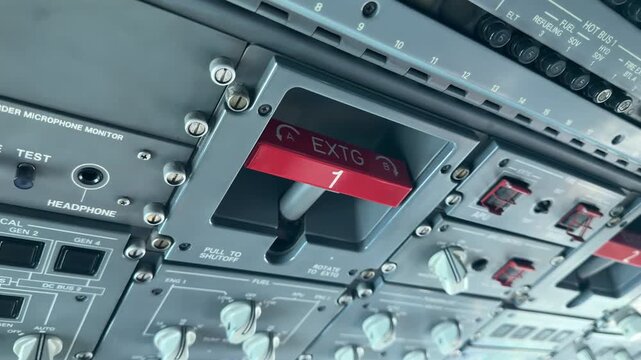 Detailed view of an ERJ cockpit fire handle and control panel, showcasing aviation technology. Ideal for educational content or aviation documentaries.