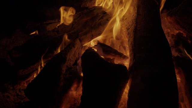 Close-up of glowing embers and firelight at a retreat in Flores, Peten, Guatemala.