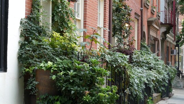 New York City urban residential buildings architecture, Manhattan classic street, Greenwich village, United States of America. Typical red brick house in NYC, real estate property in USA. West village