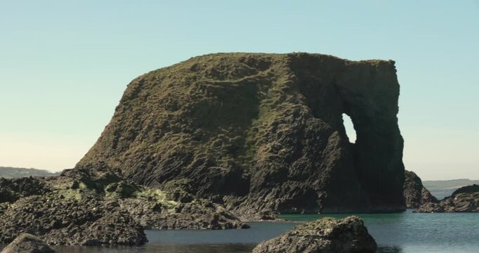 panning shot revealing the famous Elephant Rock on the Northern Ireland coast