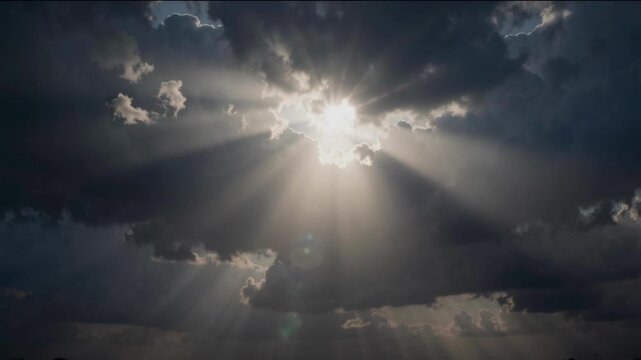 Dramatic Sun Rays Breaking Through Dark Storm Clouds Creating a Cinematic Atmospheric Light Effect
