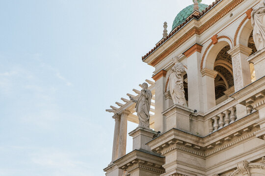 Classical stone statues and ornate arches decorating historic European architecture