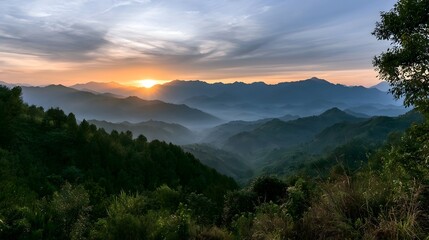 Fototapeta premium Panoramic view of layered mountains shrouded in atmospheric mist during the golden hour