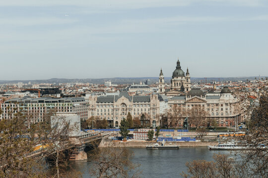 High angle view of historic bridge crossing river toward European palace architecture and basilica dome