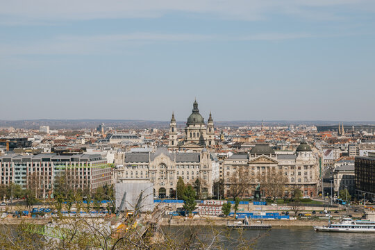 Wide high angle view of European urban skyline featuring historic basilica dome and riverfront