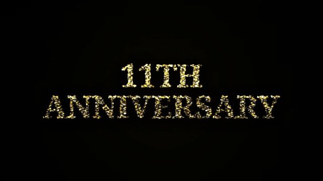Golden sparkling particles forming 11th Anniversary text on black background celebration
