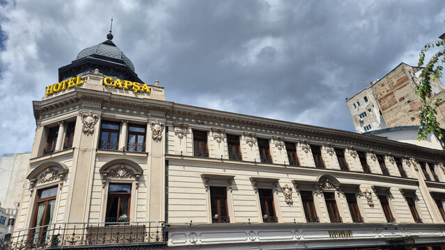 The historic Hotel Casa Capșa building in Bucharest features classic architecture under a dramatic, cloudy sky. Picture taken on May 31, 2026, Romania.