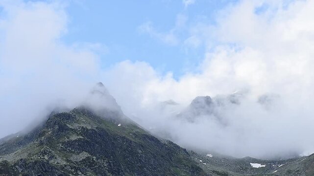 Schwarzhorn wrapped by mists, Pizzo Suretta landscape in the Montespluga range