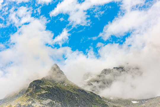Schwarzhorn wrapped by fogs, Montespluga landscape in the summer season