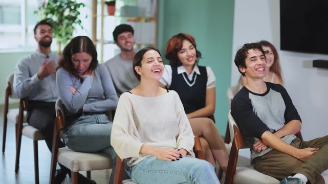 Students laugh during lecture. Lecture room is filled with listeners. Company managers during training, introductory training for staff, professional development courses, educational seminar.