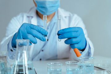 Fototapeta premium Scientist Comparing Test Tube Samples in Laboratory