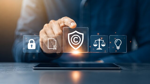 Hand interacting with glowing copyright shield and legal icons on a tablet representing digital intellectual property and patent protection