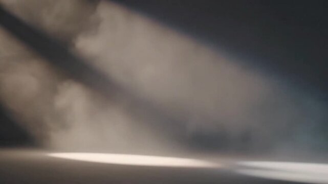 Dramatic light rays piercing through a smoky or dusty atmosphere, creating a mysterious and ethereal scene.