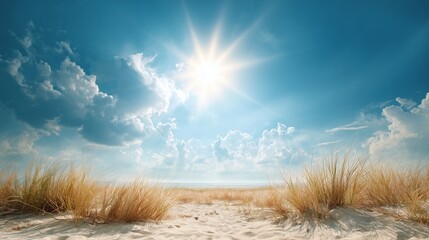 Bright sun shining in a clear blue sky over a sandy beach with dunes.
