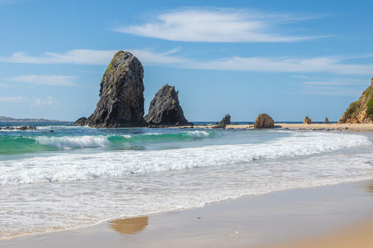 Sea stacks, part of the glasshouse rock formations, stand out in the turquoise waters of the Pacific Ocean in an ancient geological subduction zone at Narooma in New South Wales, Australia.