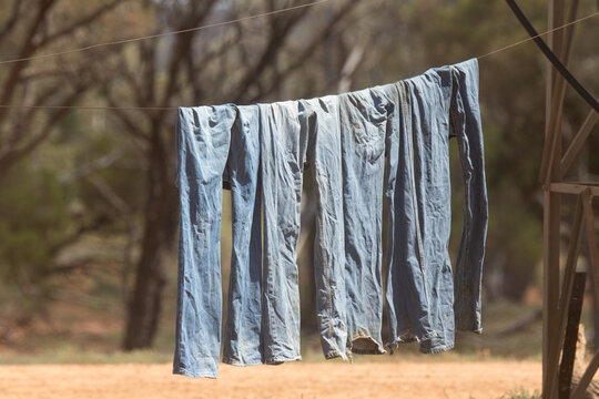 Work jeans hanging on a wire