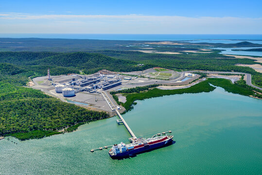 Aerial view of liquified natural gas plant and LNG ship docked at a long pier