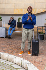 Vertical video: Adult man tapping phone, checking ETA in transit hub, showing AR times over case © wavebreak3