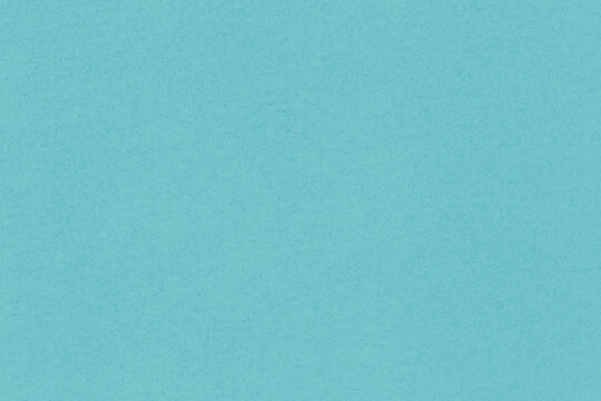 blank turquoise backdrop: close up of speckled craft cardboard texture