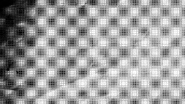Stop motion animation of dark grey crumpled paper texture background with rough creases and folded grunge pattern, 4k video