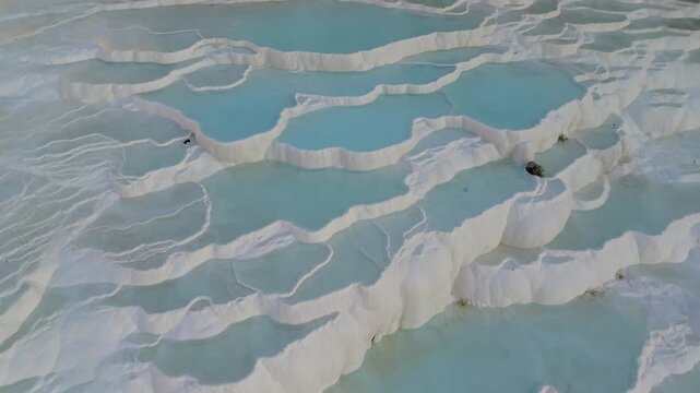 Discover the breathtaking white travertine terraces of Pamukkale, Turkey. Denizli Pamukkale nature terraces, travertine pools