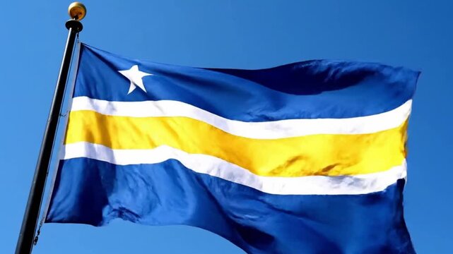 The national flag of curacao waving against a clear blue sky