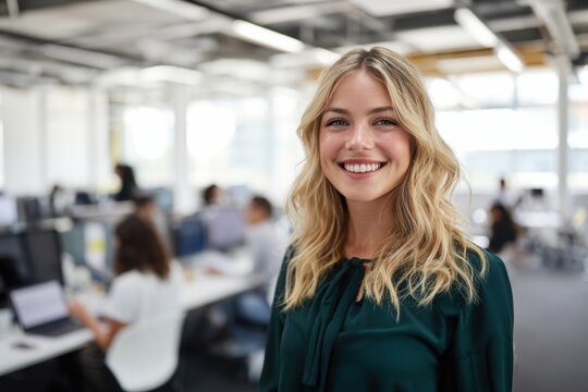 The Young Professional Woman Smiling in a Bright Modern Open Office