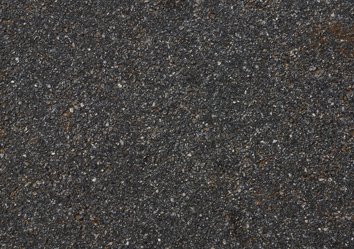Asphalt road surface showing textured dark pavement