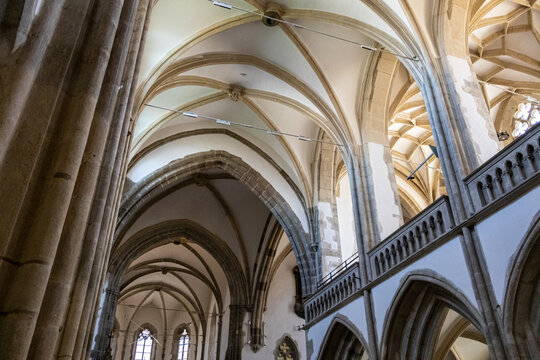 Towering Stone Column and Arches inside Ancient Cathedral