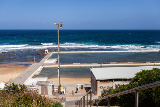 Merryweather ocean baths closed on bright sunlit day flying red warning flag