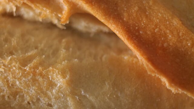 50p macro slider shot moving above the crust of artisan bread