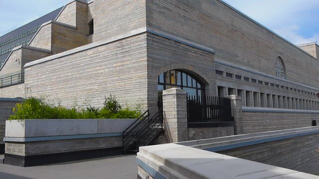 Brutalist soviet modernism architecture of the National Library of Estonia in Tallinn, with its terraced limestone facade and distinctive geometric shapes under a clear summer sky