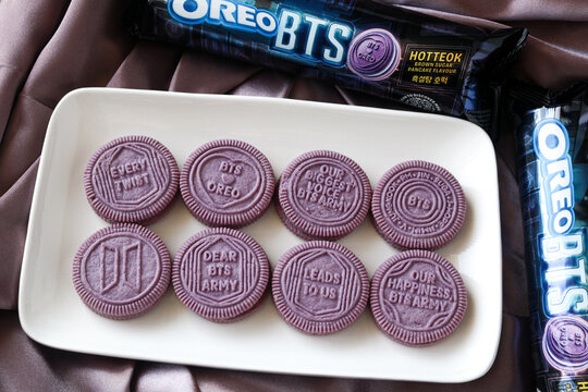 Tangerang, Indonesia - June 7, 2026: Overhead view of eight purple Oreo BTS collaboration cookies arranged on a white serving plate.