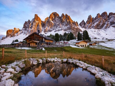 Geisleralm with Geisler Group in Alpengl&uuml;hen, reflection, Dolomites, Santa Magdalena, Trentino, South Tyrol, Italy