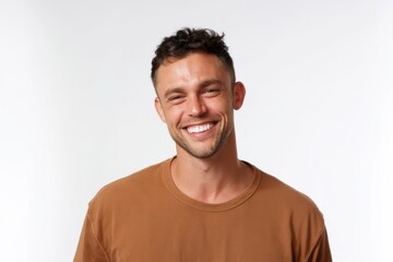 Fototapeta premium The man smiling confidently in a brown tshirt studio headshot portrait exuding warmth