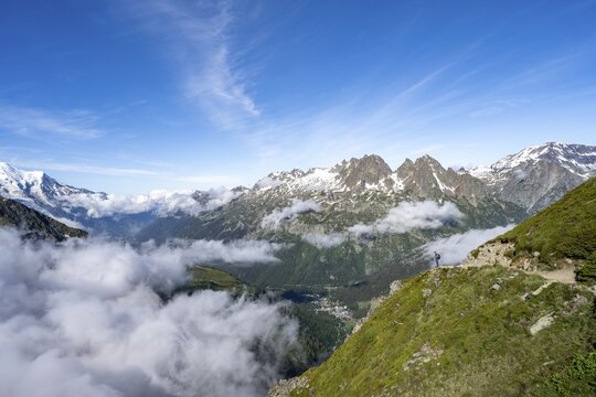 Mountaineer on hiking trail, high alpine mountain landscape, mountain panorama with view over the valley of Chamonix, in the background summit of Mont Blanc and Aiguilles Rouges, Chamonix, Haute-Savoie, France