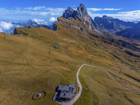 Sofie hut, behind the peaks Sas Rigais and Furchetta of the Geisler group, drone shot, Val Gardena, Dolomites, Autonomous Province of Bolzano, South Tyrol, Italy