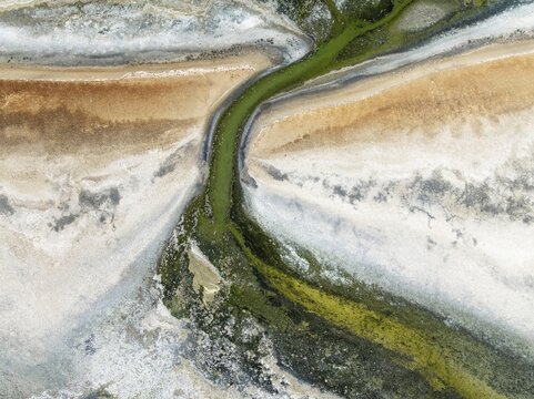 Marshes and streams at low tide in the Walvis Bay Lagoon. Aerial view. Drone shot. Walvis Bay, Namibia