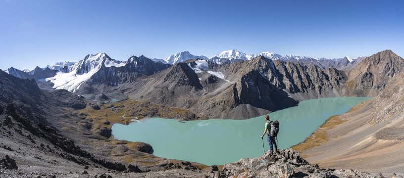 Panorama, mountaineers on the way to the Ala Kul Pass, view of mountains and glaciers and turquoise Ala Kul mountain lake, Tien Shan Mountains, Kyrgyzstan