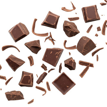 Falling pieces of dark chocolate chunks and shaved curls scattered in midair isolated on a transparent background