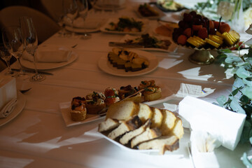 Formal dining table setup with gourmet appetizers, fresh fruit, and elegant glassware © Darius