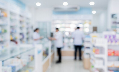 Obraz premium A blurry image depicting a pharmacy interior with staff attending to customers amidst shelves filled with various medications and health products.